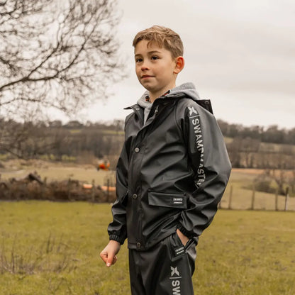 Child wearing Xpert Swampmaster Stormgear Junior Waterproof Jacket and trousers outdoors